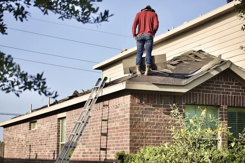 Professional roofer working on a residential roof in Haven Homes
